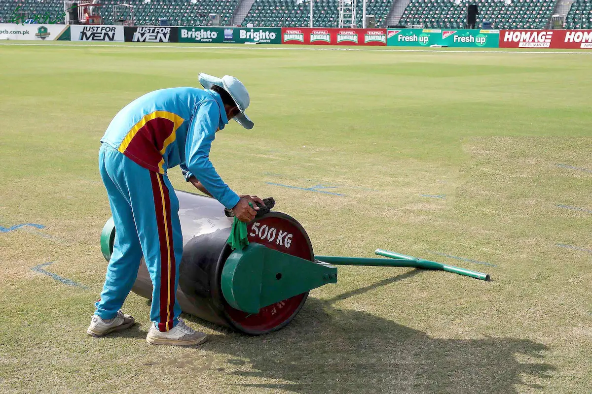 Groundsman cleaning a 500 kg Manual Turf Roller