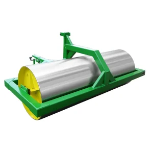 Green and yellow tractor-operated field roller with a large silver galvanized steel drum for soil compaction.