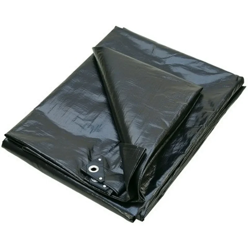 Matt black PVC cricket pitch cover sheet spread on a grass wicket.