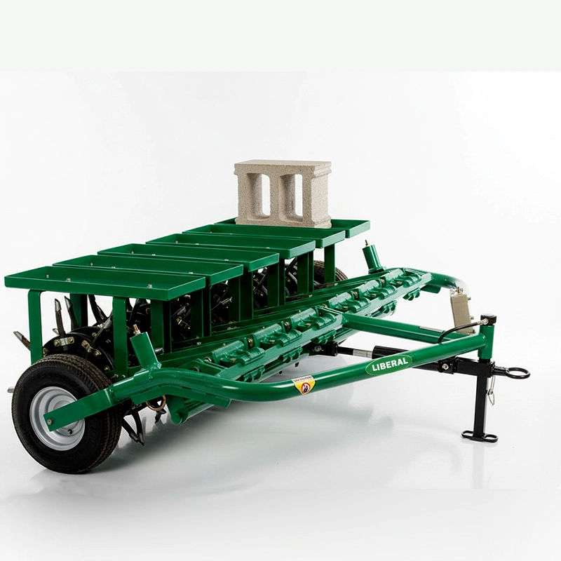Liberal Spike Machine Aerator trailed behind a tractor with additional concrete weight blocks for deeper soil compaction.